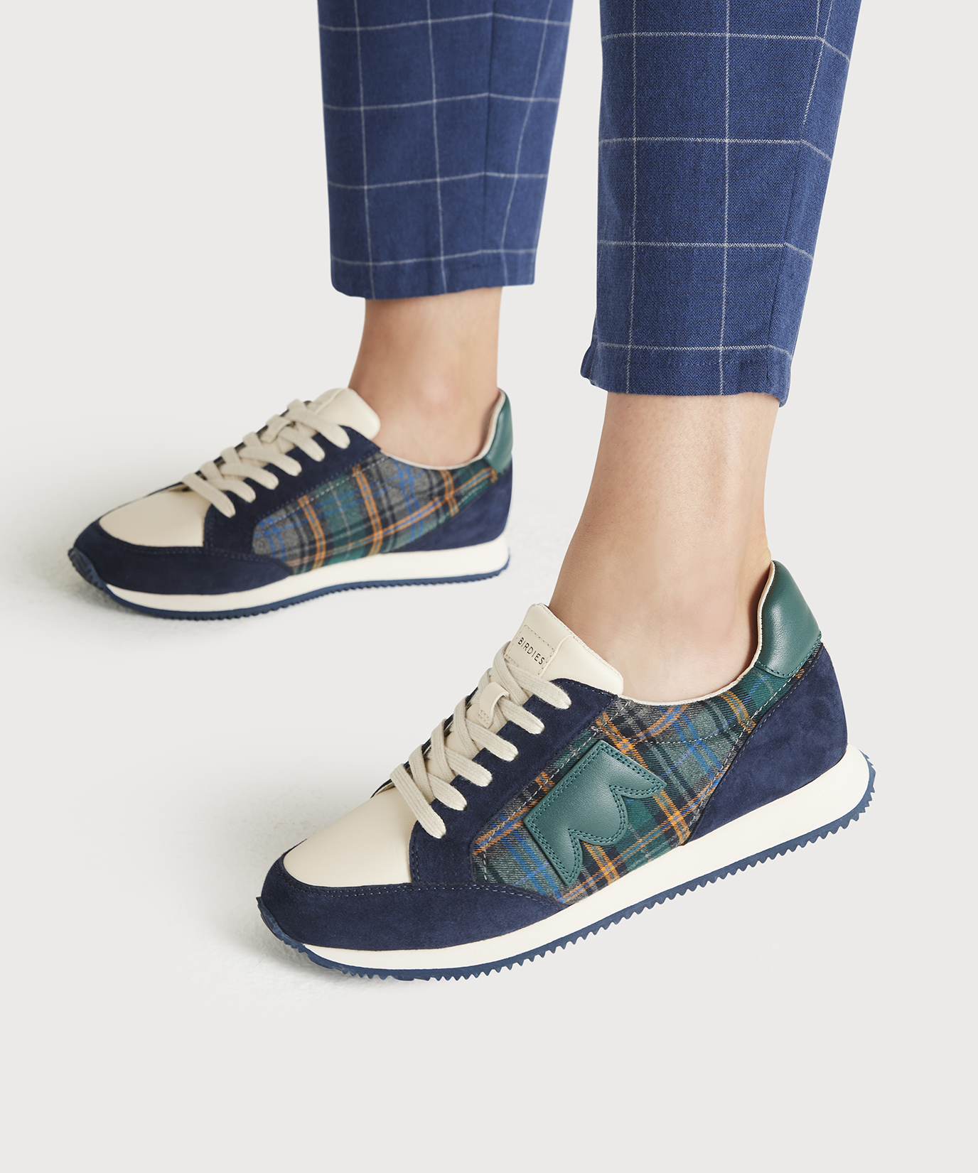 on figure side view of the Roadrunner Sneaker in Navy Plaid Suede