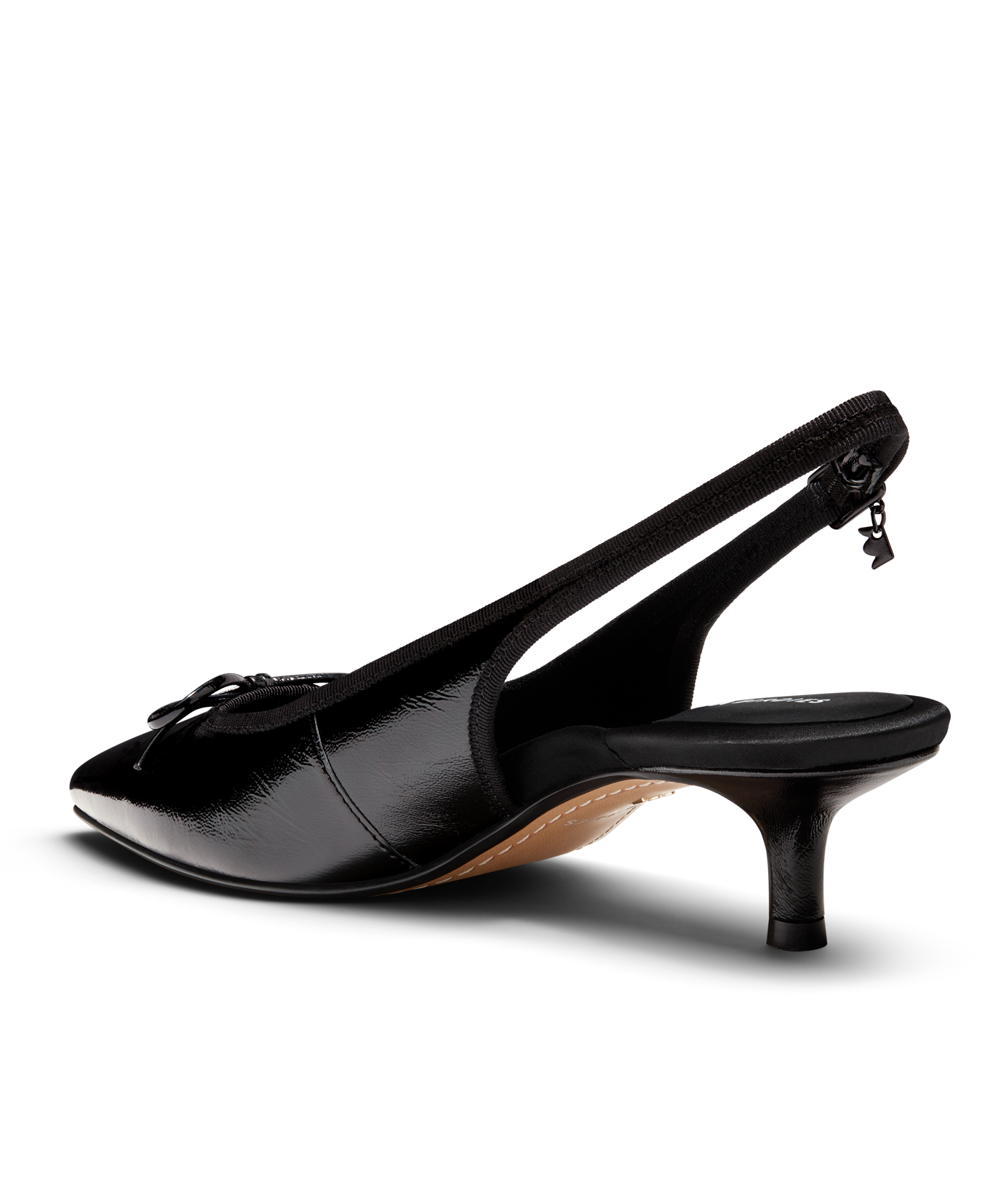 Black patent leather slingback kitten heel with pointed toe and delicate bow detail, featuring a glossy finish. Back angled view.