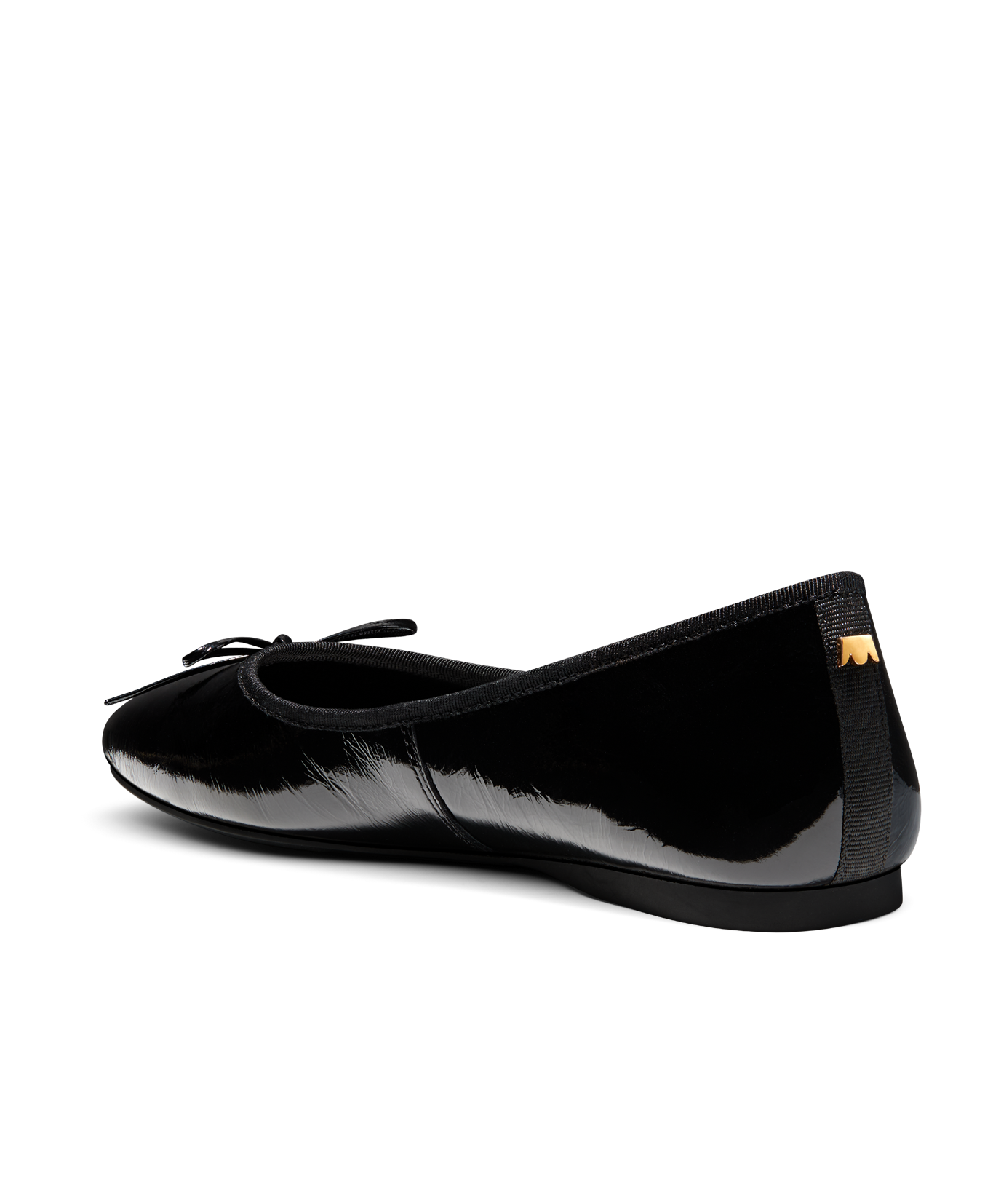 Black patent leather ballet flat with delicate bow detail, featuring a glossy finish. Back angled view.