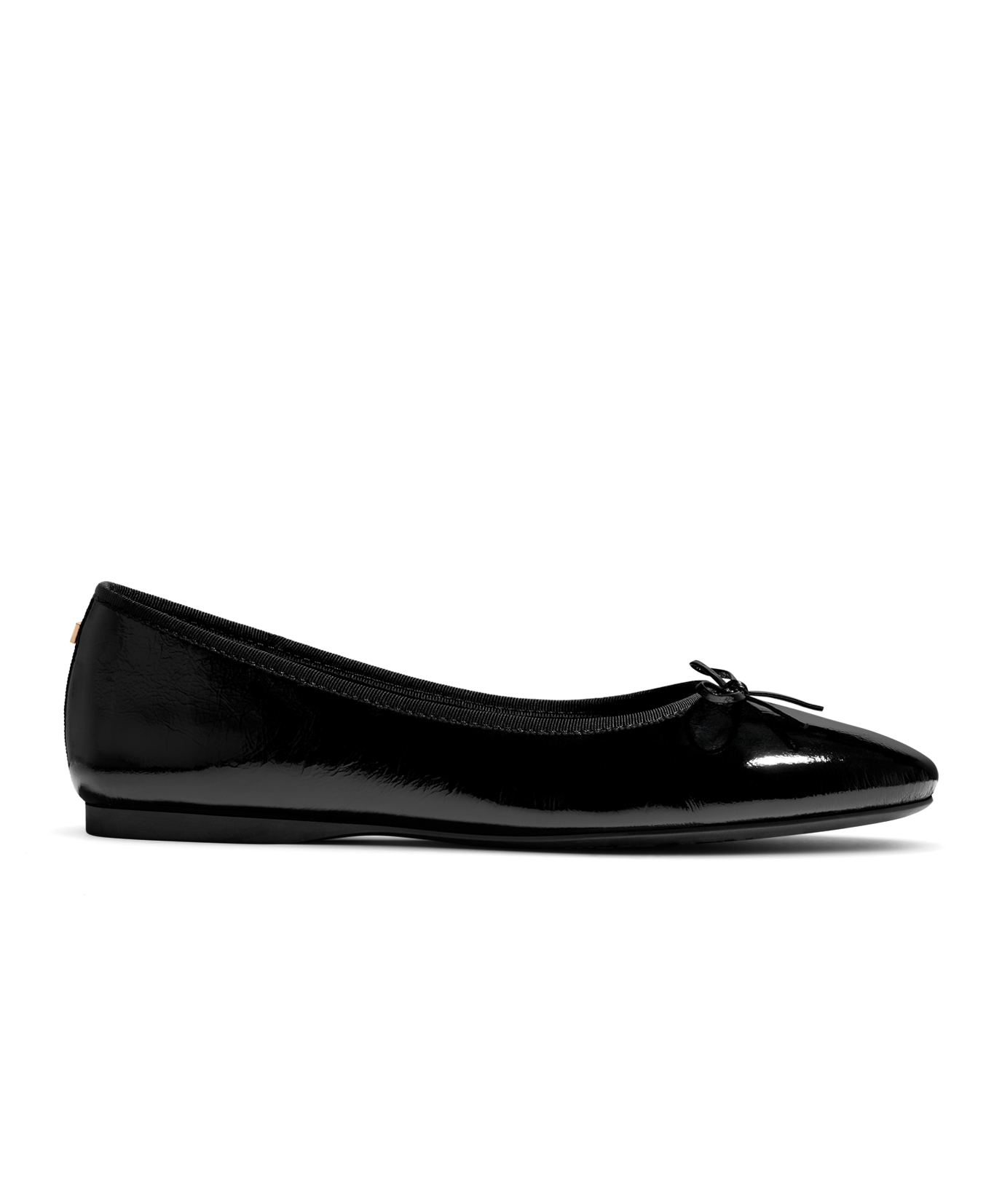 Black patent leather ballet flat with delicate bow detail, featuring a glossy finish. Side view.