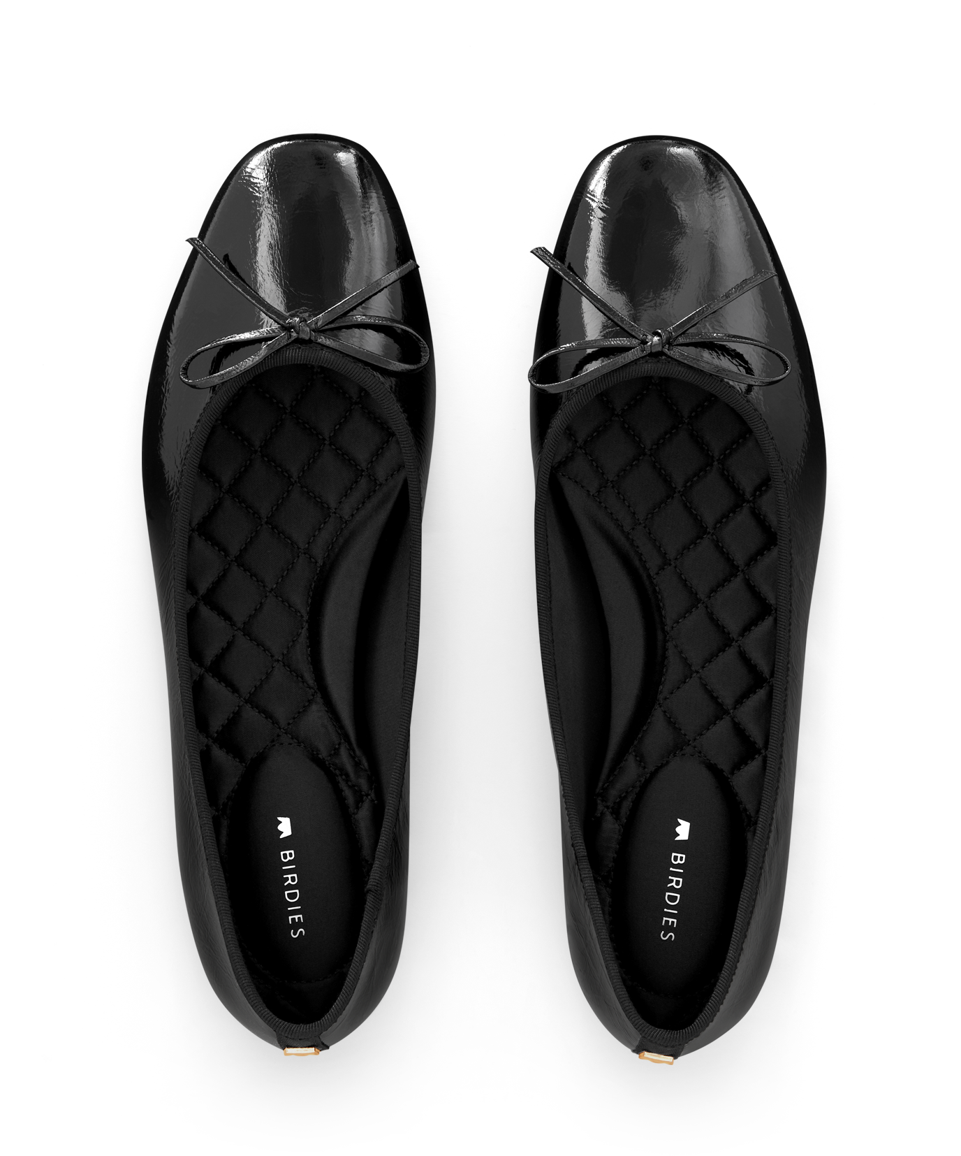 hover | Black patent leather ballet flat with delicate bow detail, featuring a glossy finish. Top view