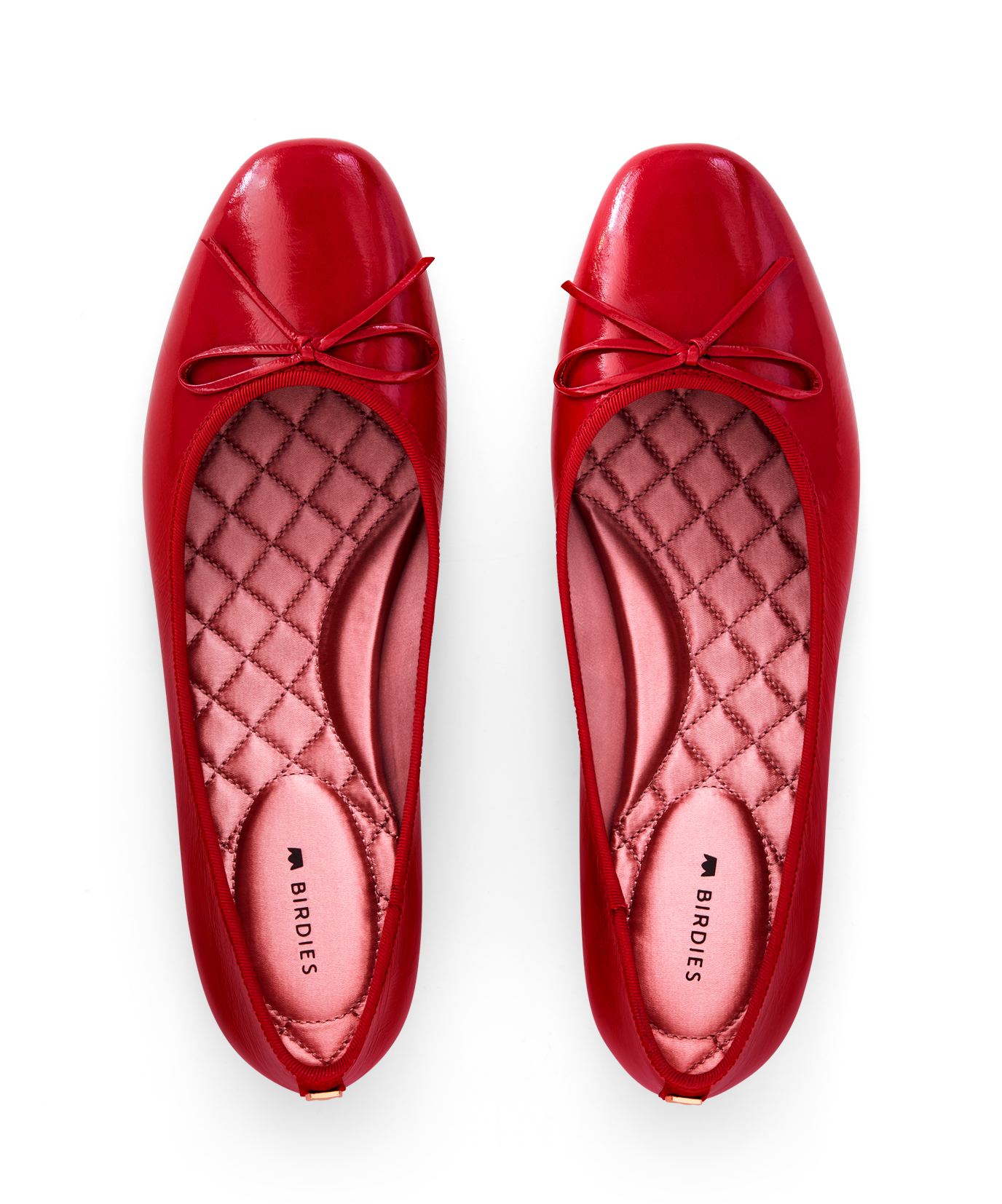 hover | Red patent leather ballet flat with delicate bow detail, featuring a glossy finish. Top view
