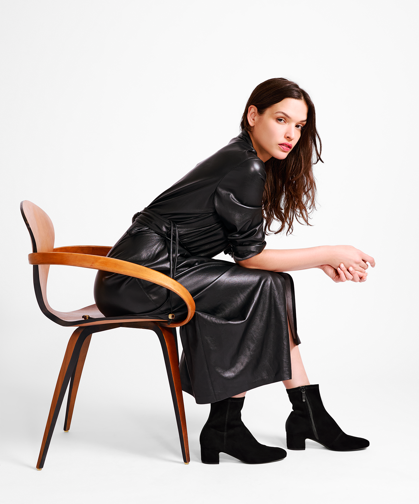 on figure side view of the Starling 50 bootie in Black Suede