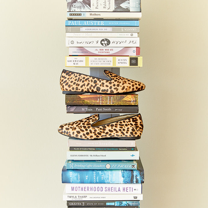 Cheetah Starling women’s flats on a bookshelf