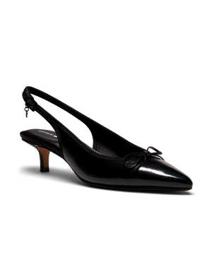 Black patent leather slingback kitten heel with pointed toe and delicate bow detail, featuring a glossy finish. Front angle view