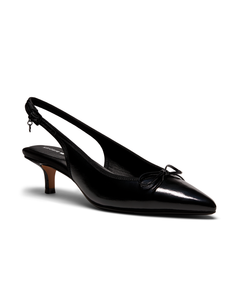 Black patent leather slingback kitten heel with pointed toe and delicate bow detail, featuring a glossy finish. Front angle view