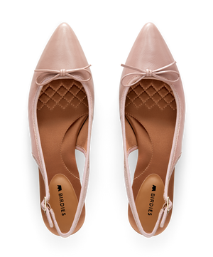 Pink patent leather slingback kitten heel with pointed toe and delicate bow detail, featuring a glossy finish. Top view.