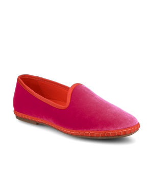 Pink slip-on shoe with orange lining on a white background