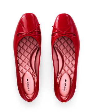 hover | Red patent leather ballet flat with delicate bow detail, featuring a glossy finish. Top view