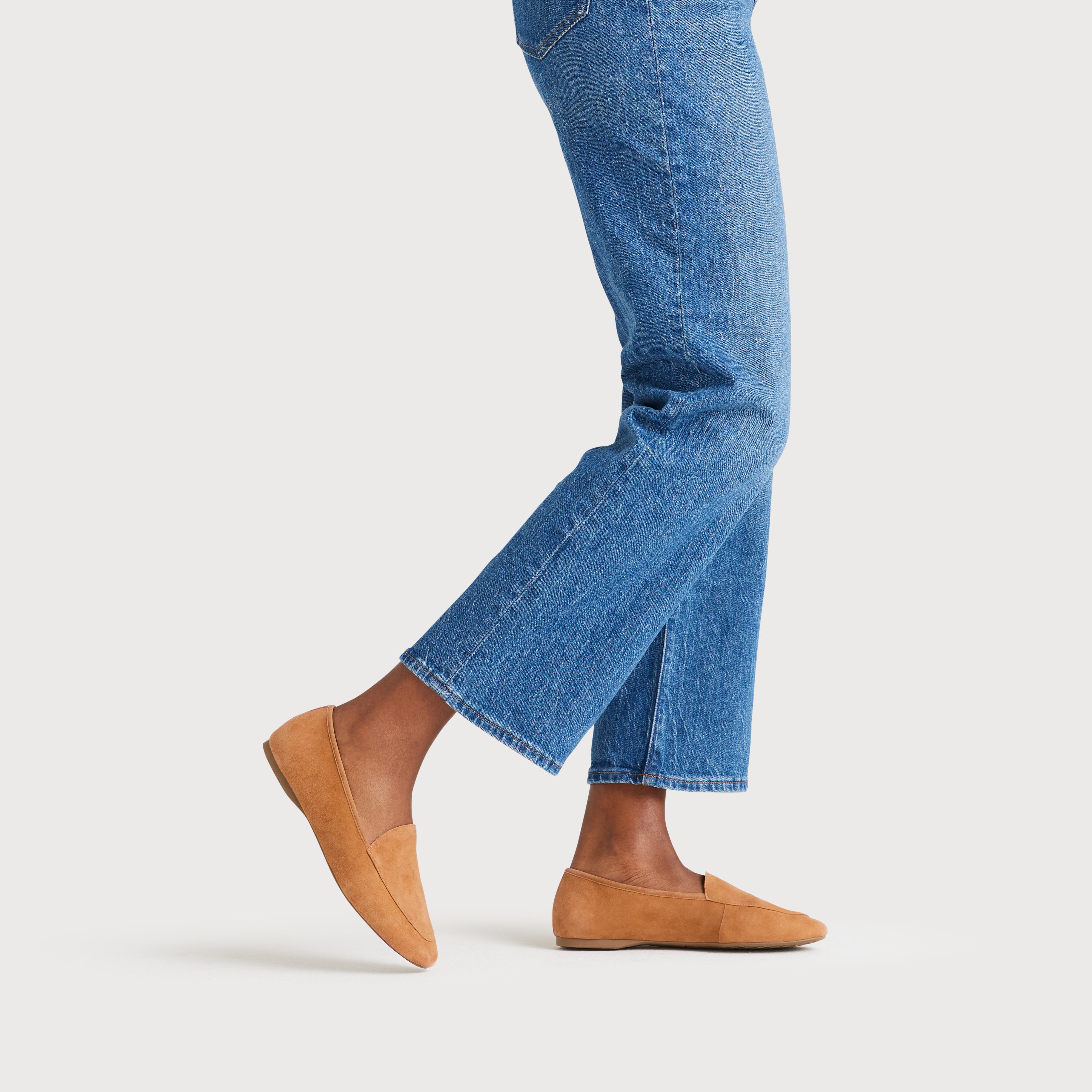 on figure side view of the Vesper loafer in Toffee (tan) Suede